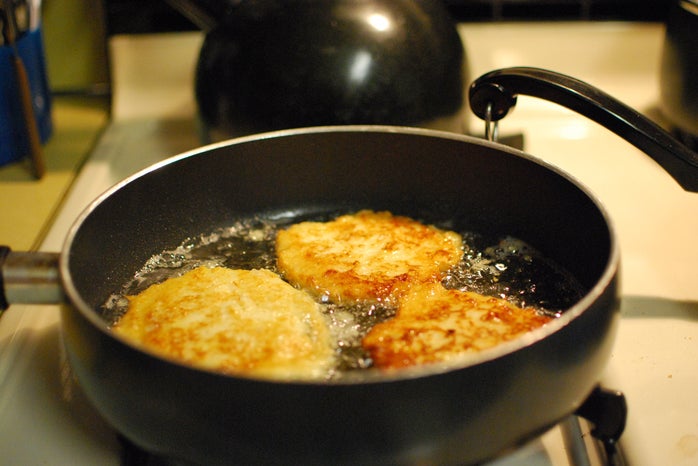 potato latkes frying in pan