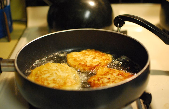 potato latkes frying in pan