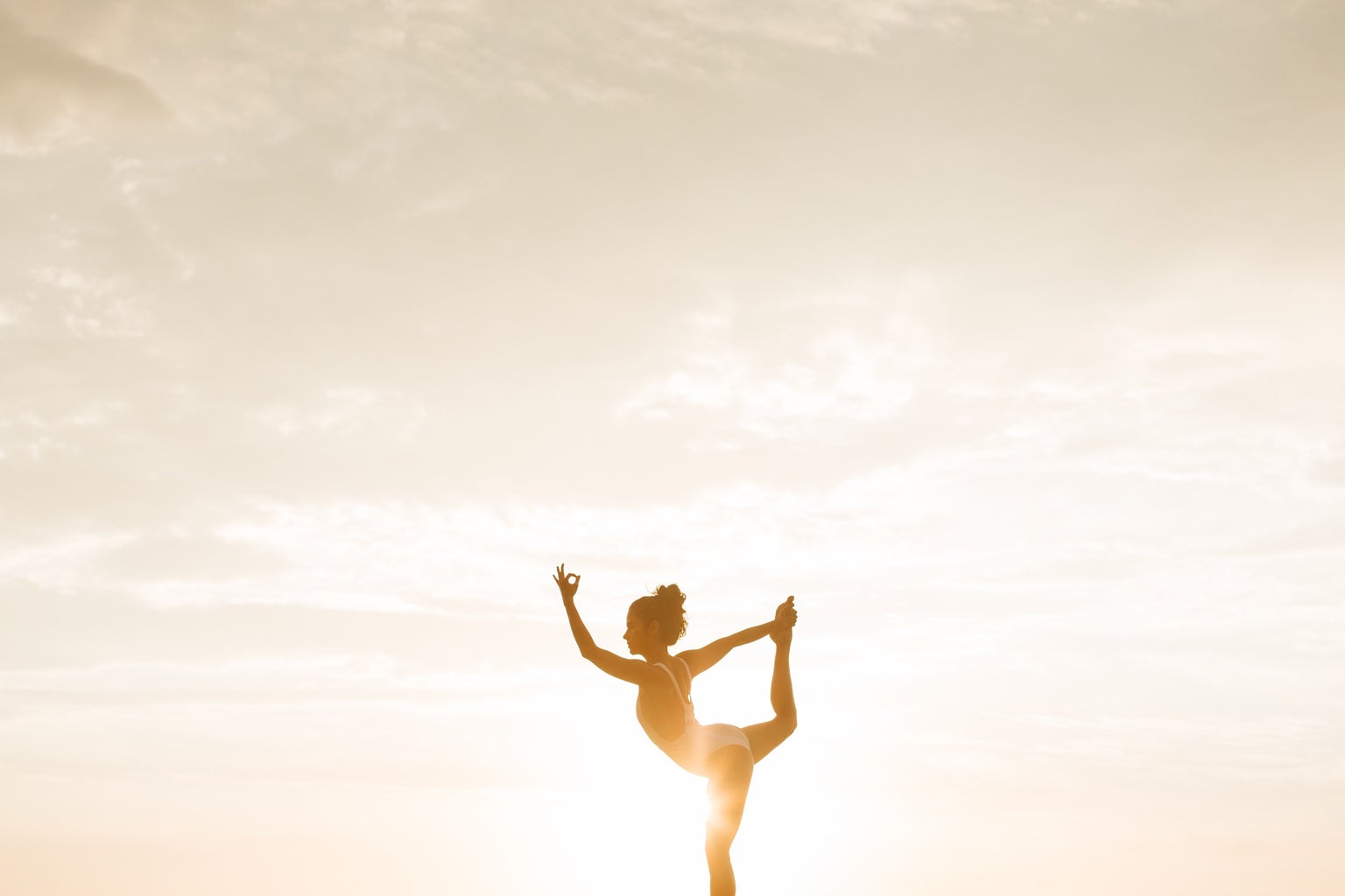 woman doing a yoga pose during golden hour