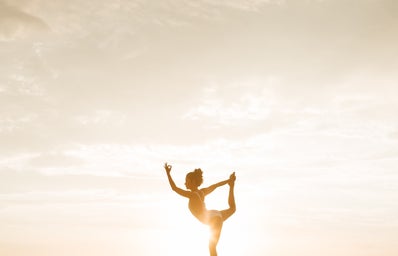 woman doing a yoga pose during golden hour