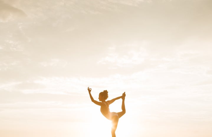 woman doing a yoga pose during golden hour