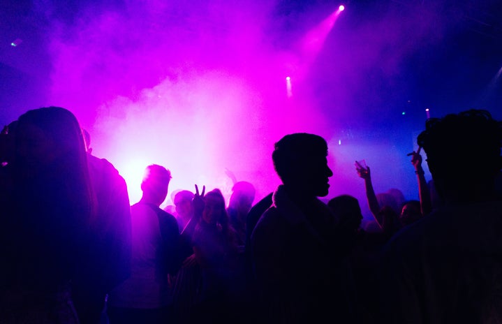 people on stage with purple lights