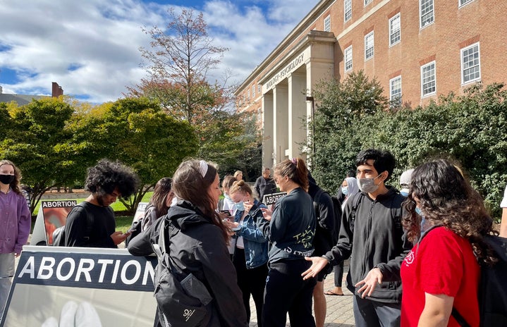 University of Maryland students arguing/discussing with an anti abortion protester