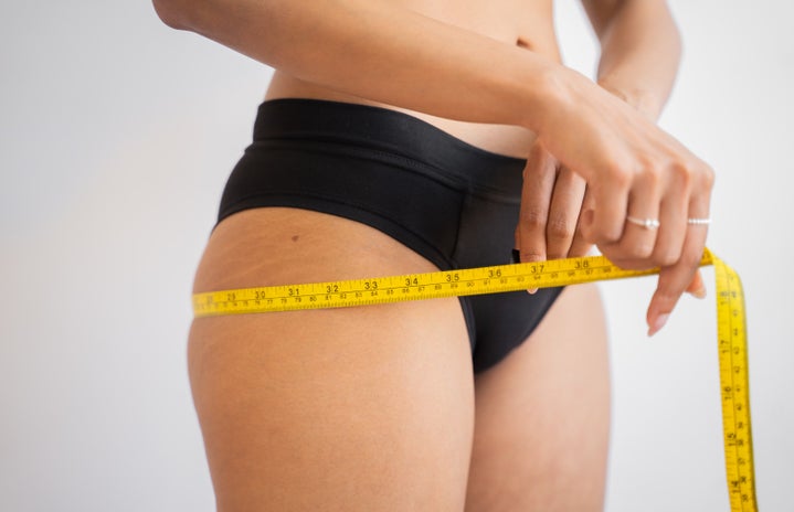 woman measuring her hips by Huha Inc?width=719&height=464&fit=crop&auto=webp