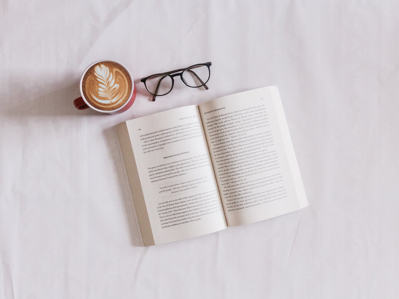 A book, coffee and a pair of glasses.