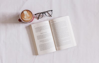 A book, coffee and a pair of glasses.