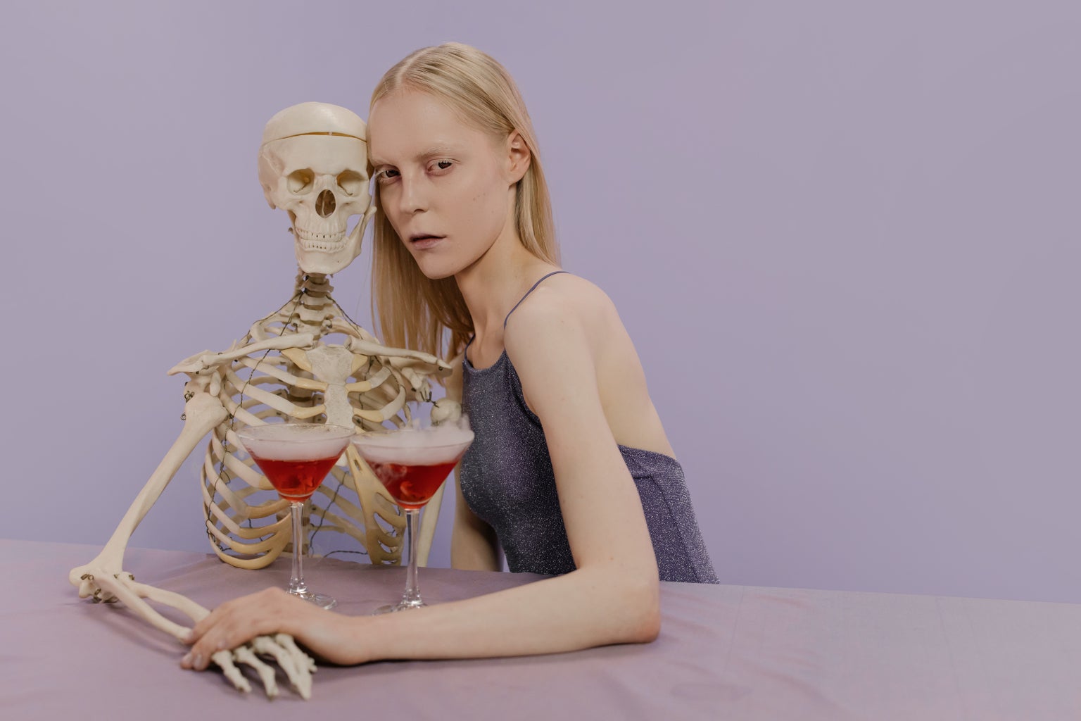 Woman and skeleton drinking