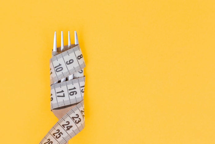 Fork with tape measure wrapped around it