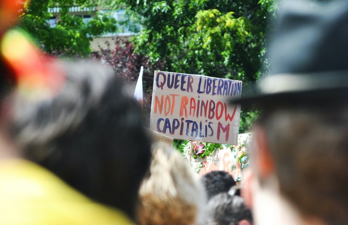 queer liberation not rainbow capitalism sign