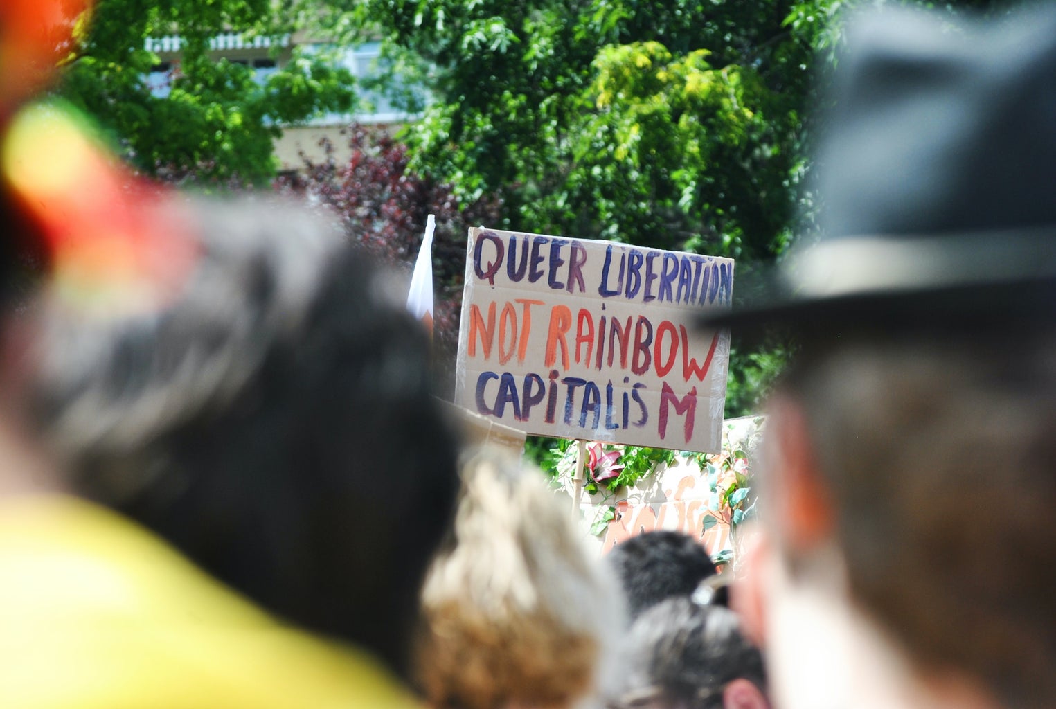 queer liberation not rainbow capitalism sign