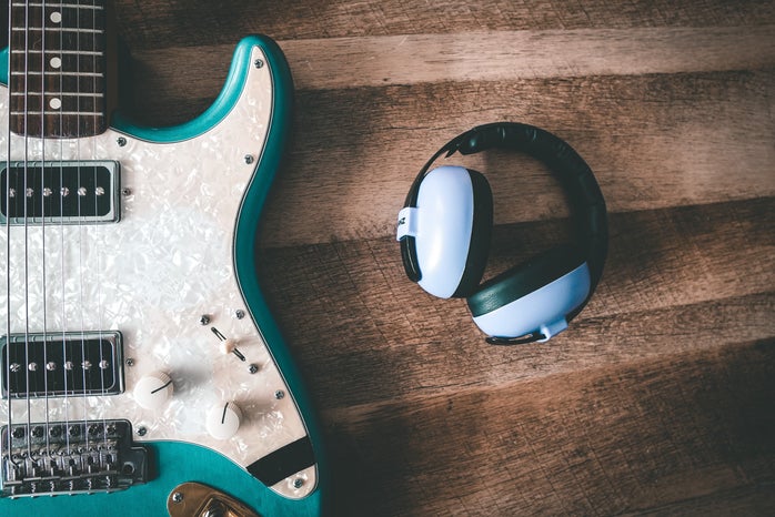headphones next to a guitar
