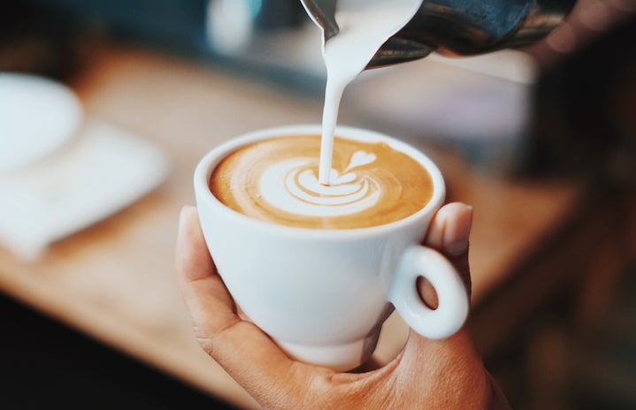 Coffee being made, milk pouring in