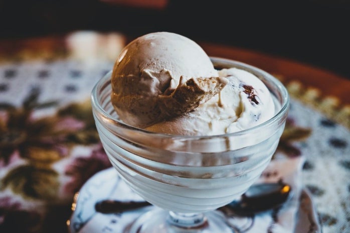 glass bowl filled with scoops of chocolate ice cream