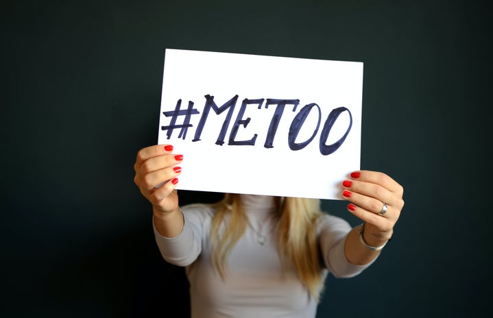 woman holding paper with #metoo
