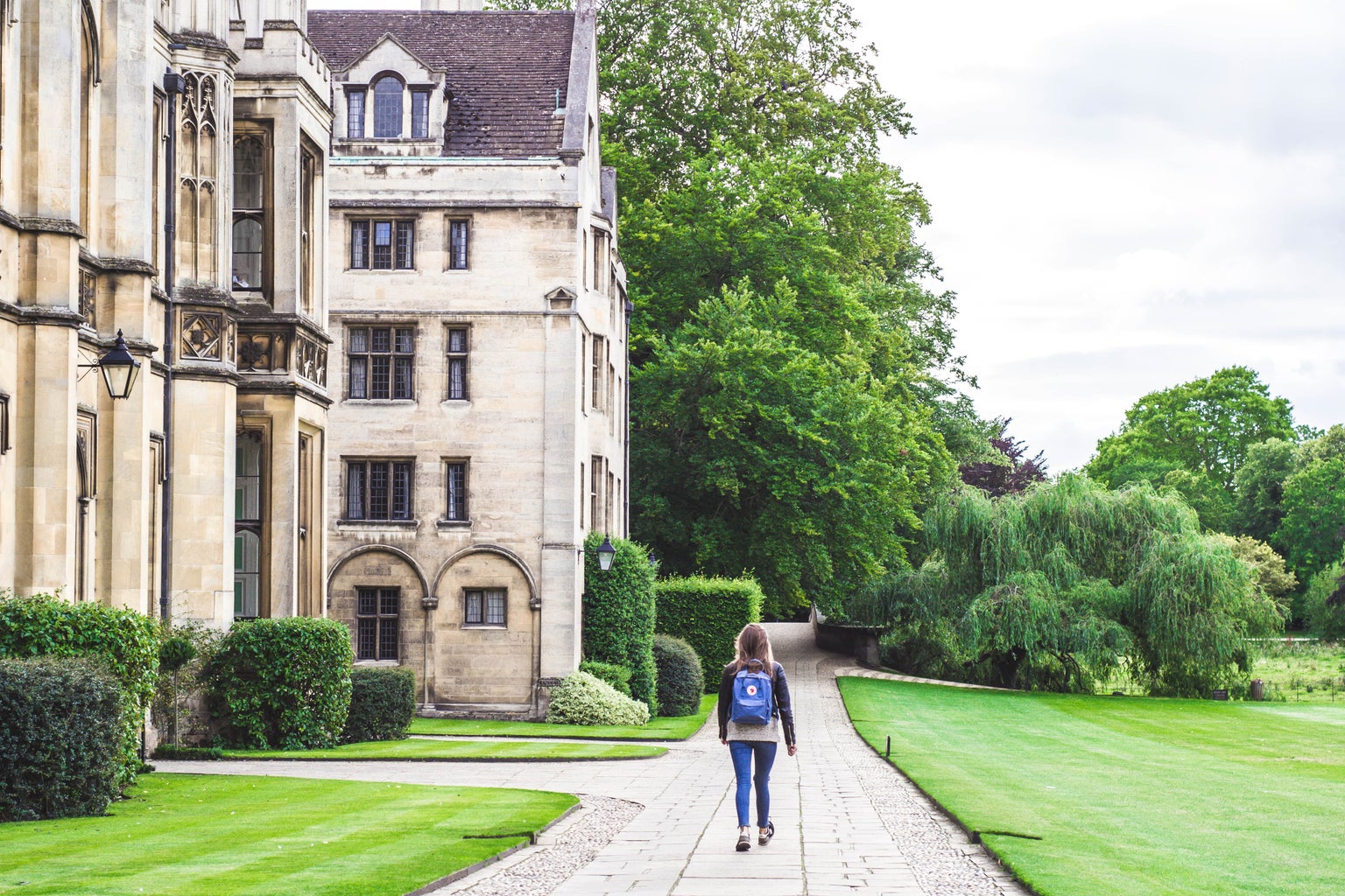 Woman walking on college campus Cambridge