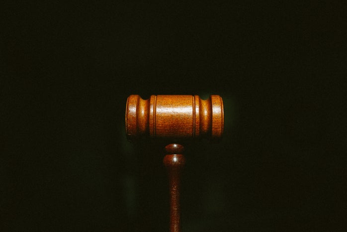 Brown wooden gavel with black background
