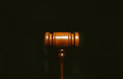 Brown wooden gavel with black background