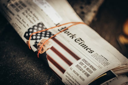 A wrapped up newspaper with a picture of Joe Biden on it