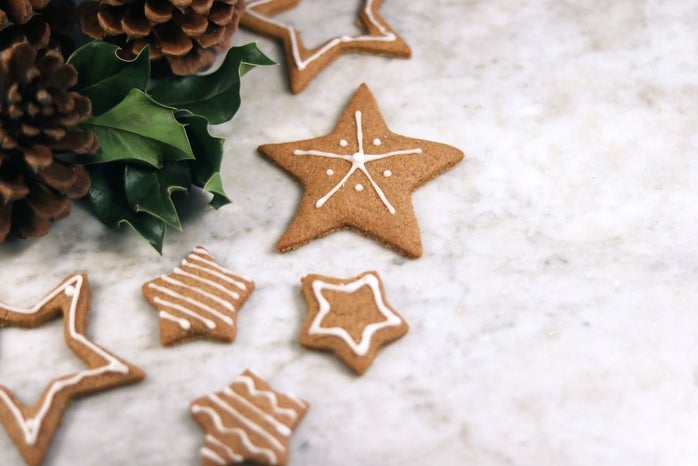 Christmas star cookies and pine cones on a marble table