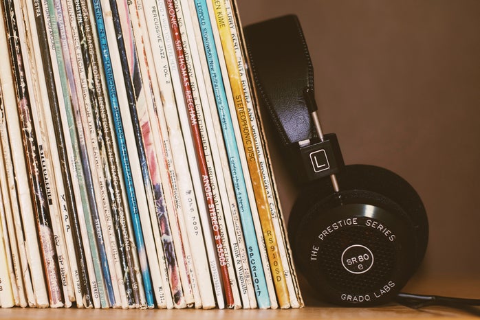 Headphones leaning against records