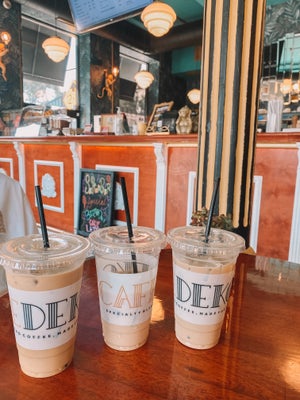 three iced coffees in a coffee shop
