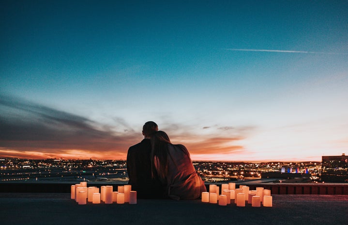 Couple sitting together watching sunset