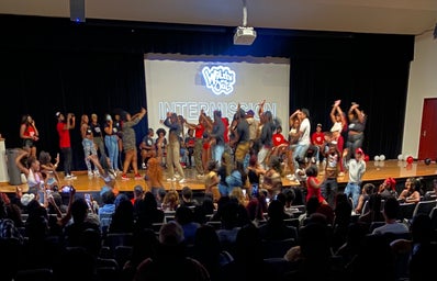 The participants of Wild \'n Out and audience members dancing and strolling on stage.