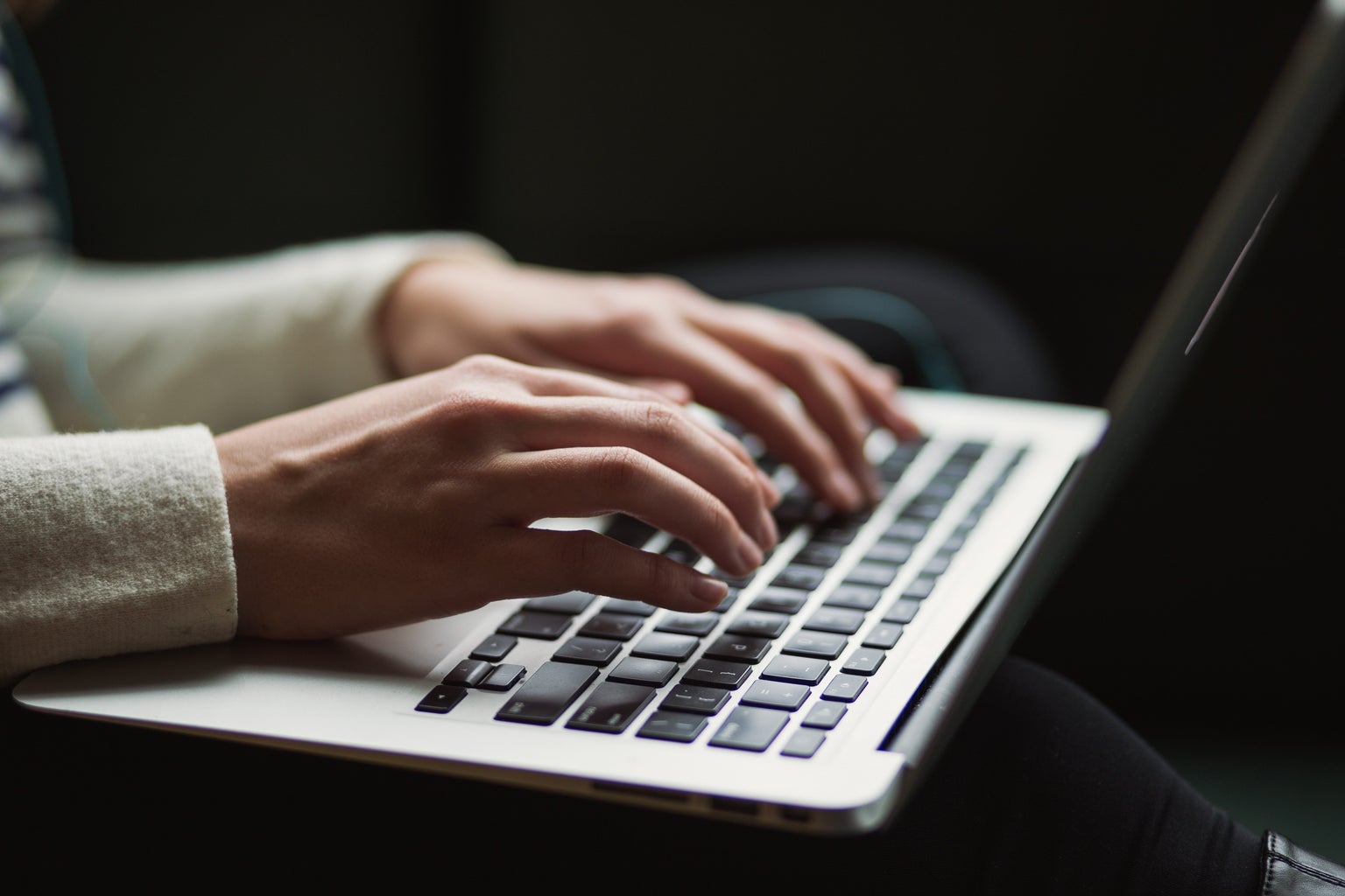 person typing on a laptop