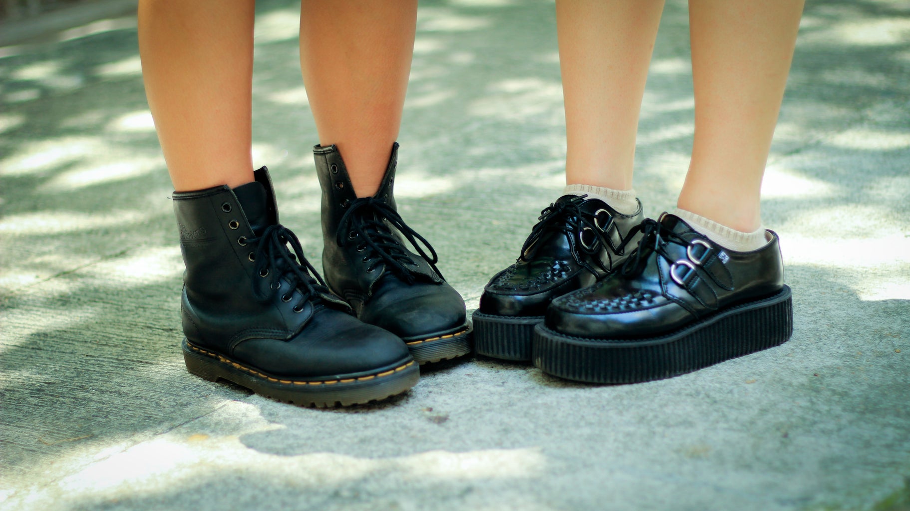 two pairs of platform black boots