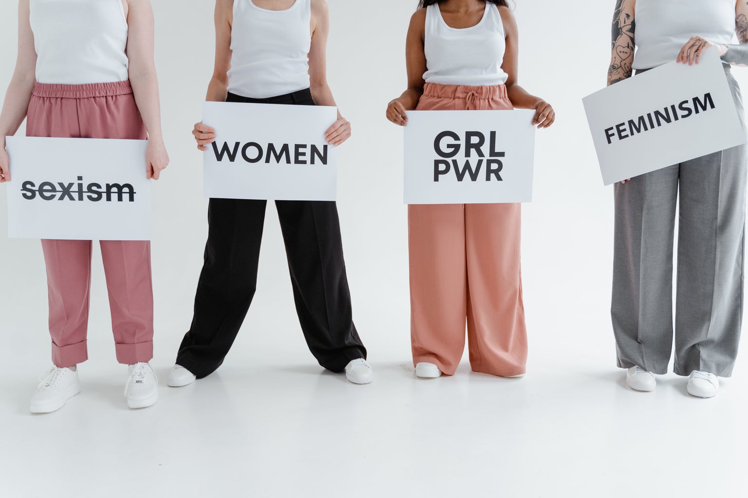 women holding cardboard signs