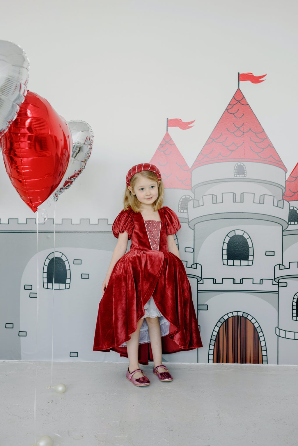 girl dressed as princess in front of castle background