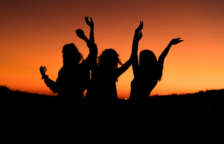 three silhouettes in orange sunset