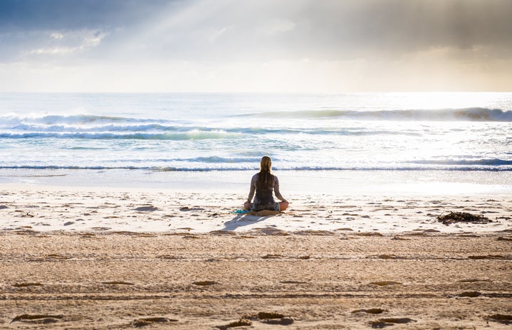 woman meditating on the beach by Simon Rae from unsplash?width=719&height=464&fit=crop&auto=webp