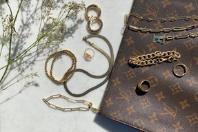 gold jewlery on marble table