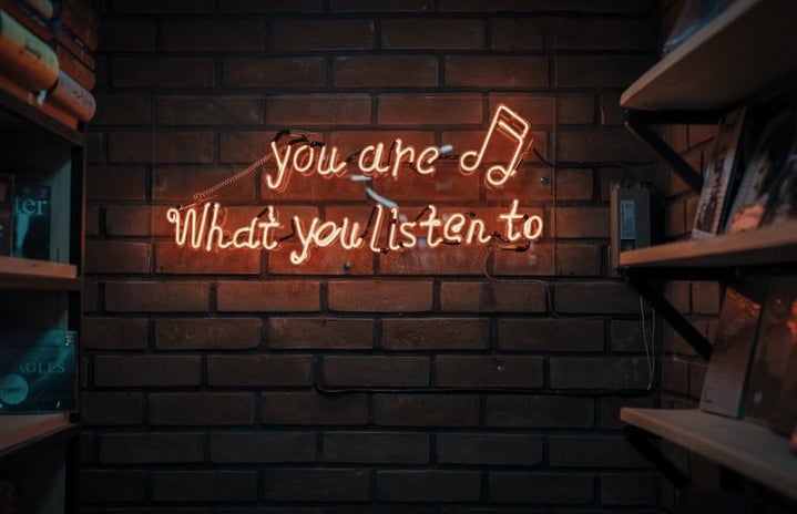 Orange LED sign that says "you are what you listen to"