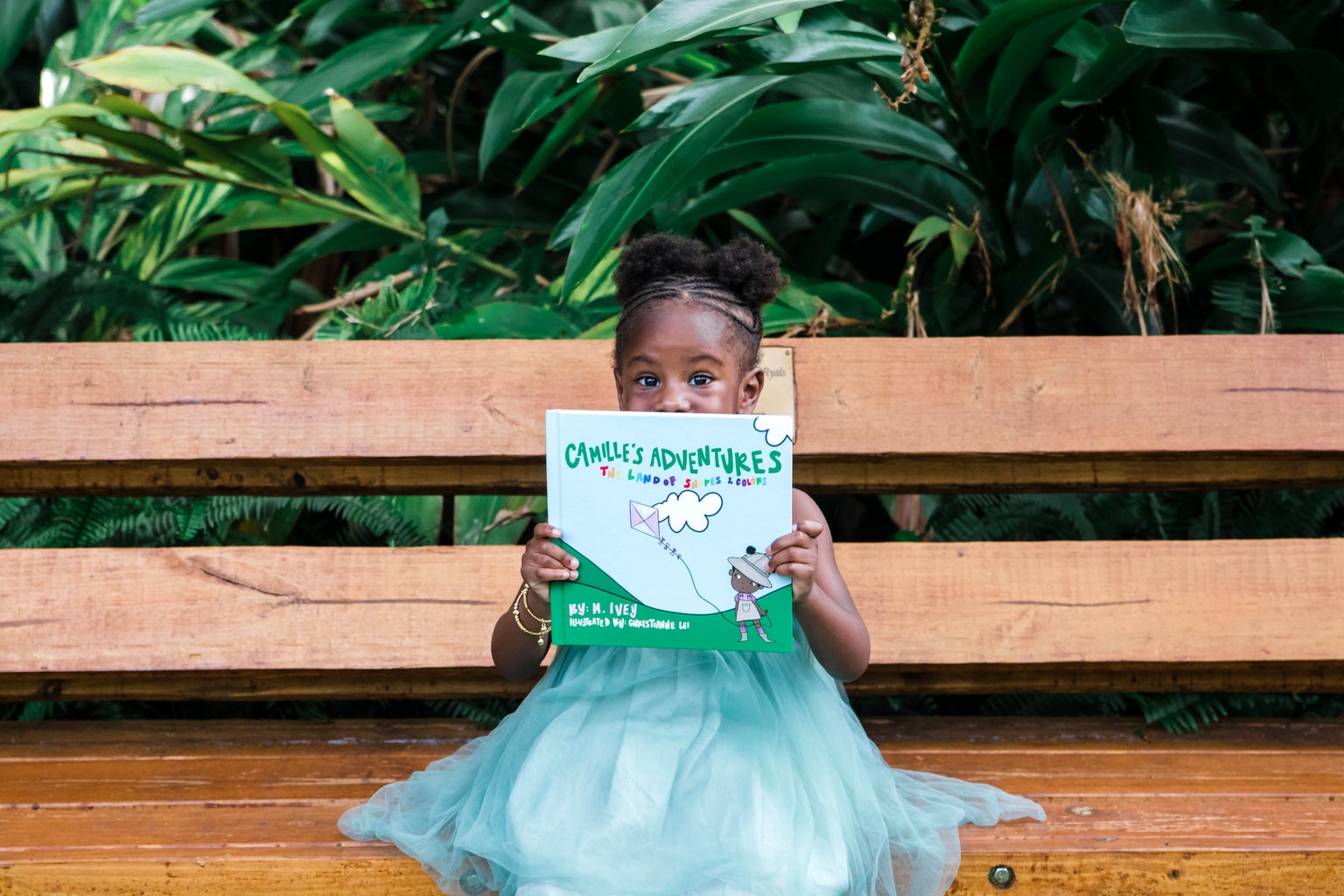 header photo for ever ivey publishing article (Mekayla holding children\'s book)