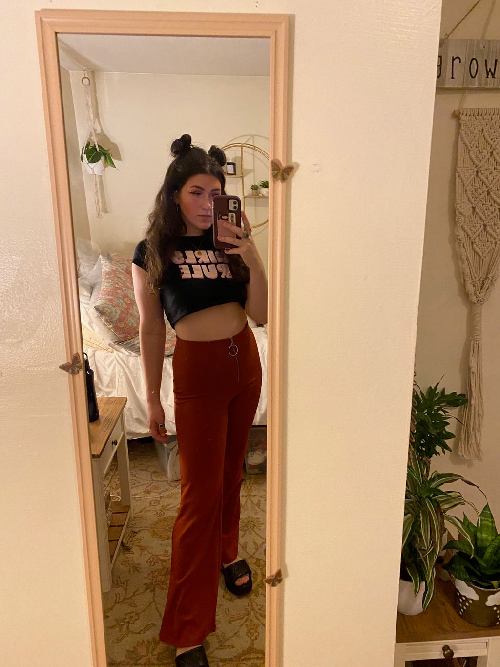 women wearing a \"girl power\" posing in front of a mirror