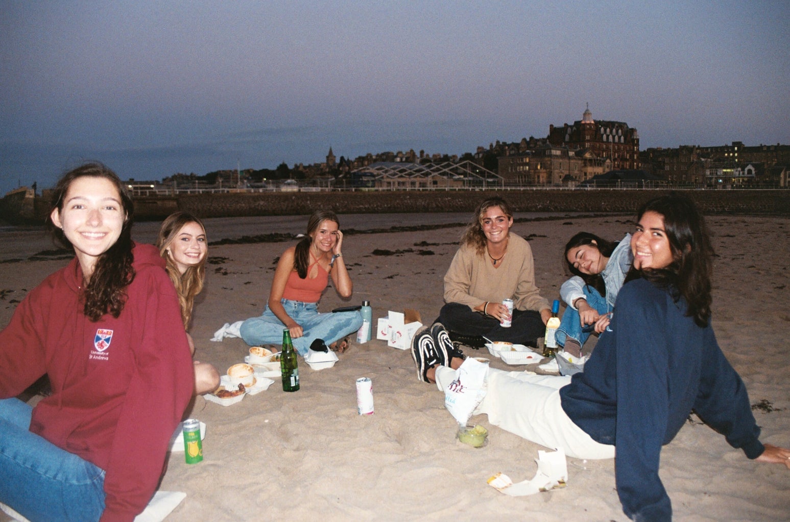 group of girls having a picnic on the beach