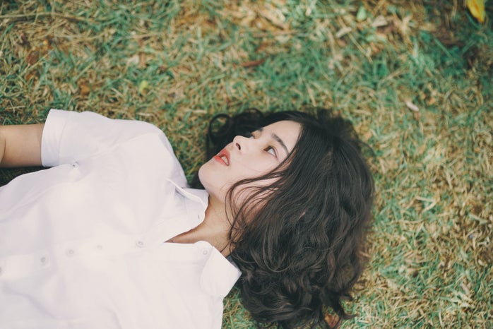 Woman lies in the grass by Shine Tang?width=698&height=466&fit=crop&auto=webp