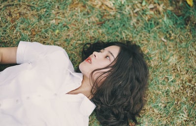 Woman lies in the grass