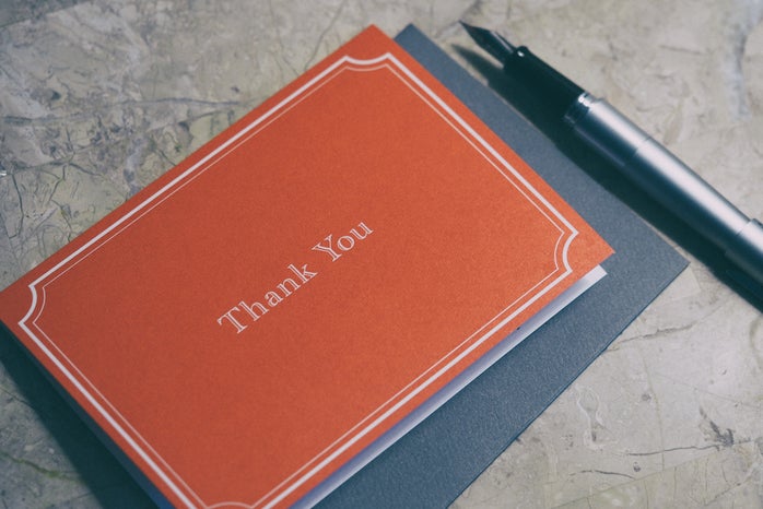 Red thank you note and pen