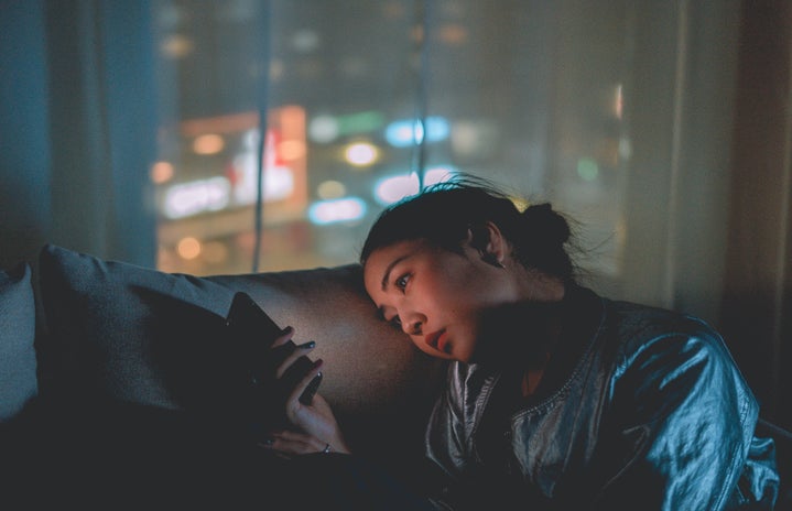 Woman staring at phone at night by mikotoraw?width=719&height=464&fit=crop&auto=webp