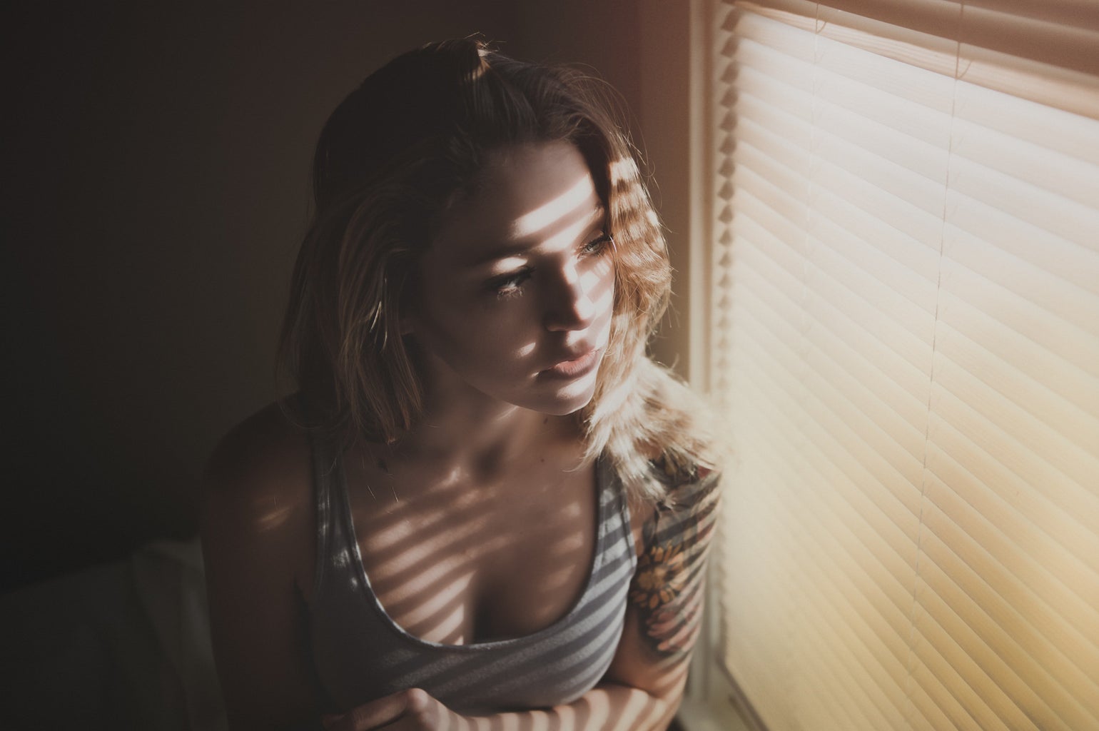 lonely woman looking out a window