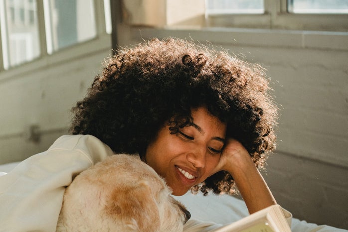 Women reading on bed with dog by Samson Kate?width=698&height=466&fit=crop&auto=webp