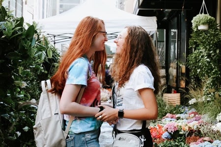 Girlfriend and girlfriend posing at market