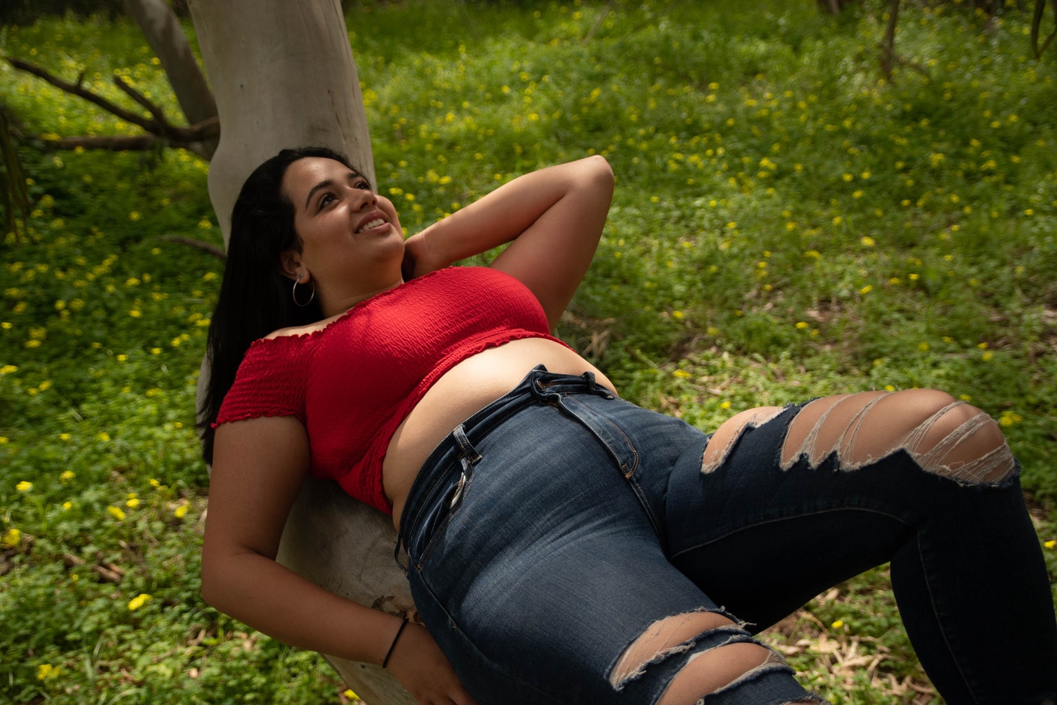 woman in red tank top and black jeans