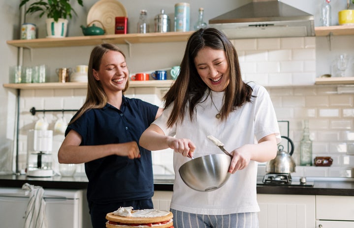 Women laughing and baking.