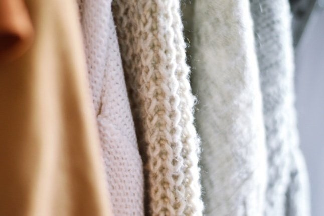Close up image of sweaters and their knit material texture