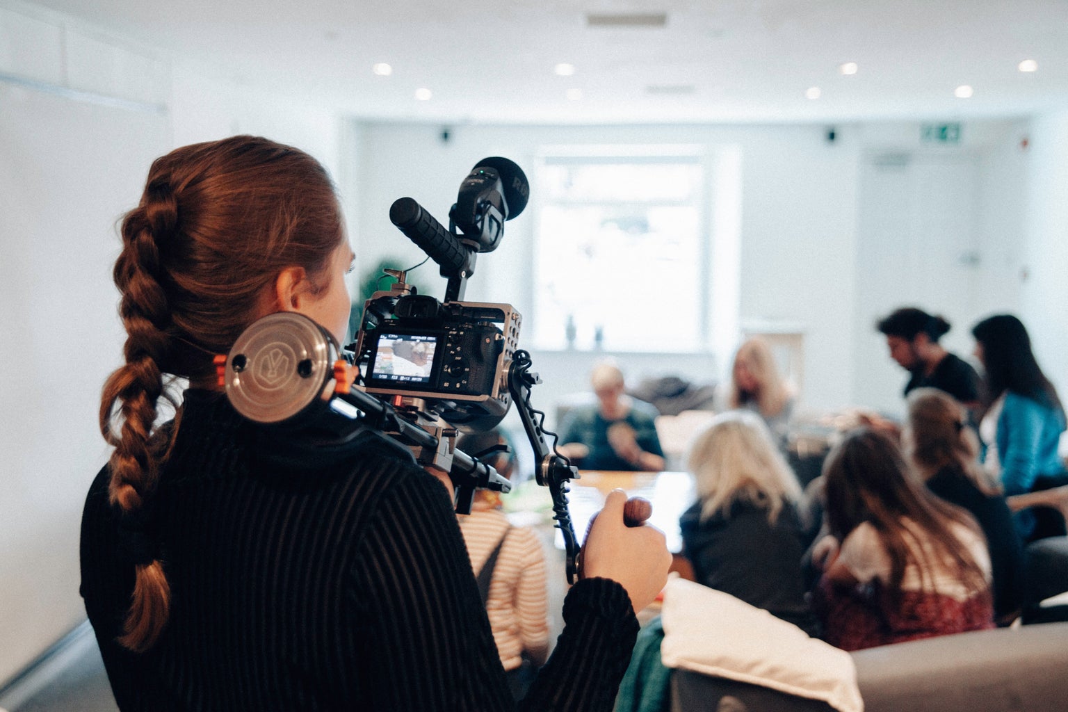 Woman filming a group scene