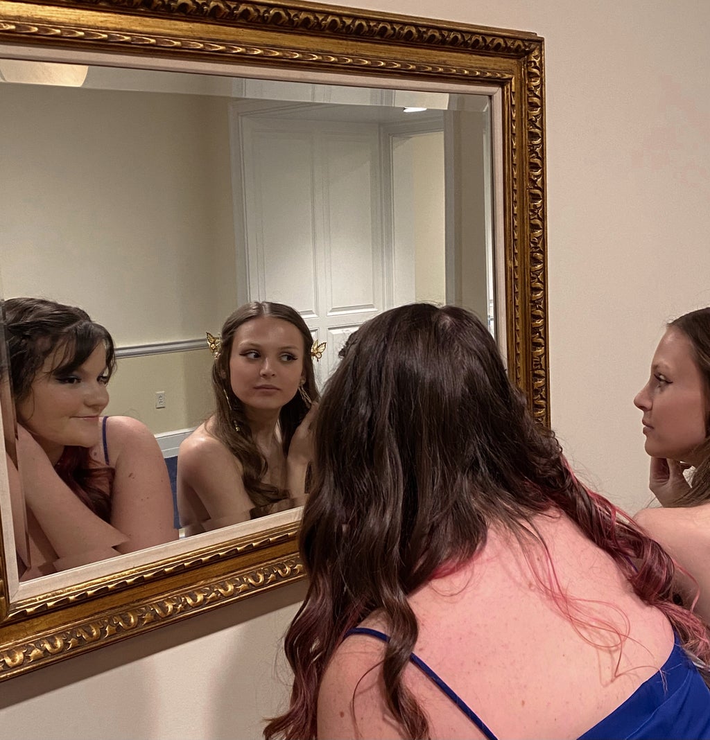 girls getting ready in the mirror